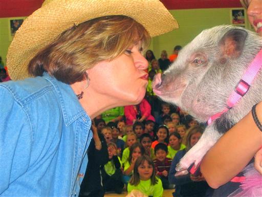 Mrs. Pam Mitchell Kissing Pig.jpg